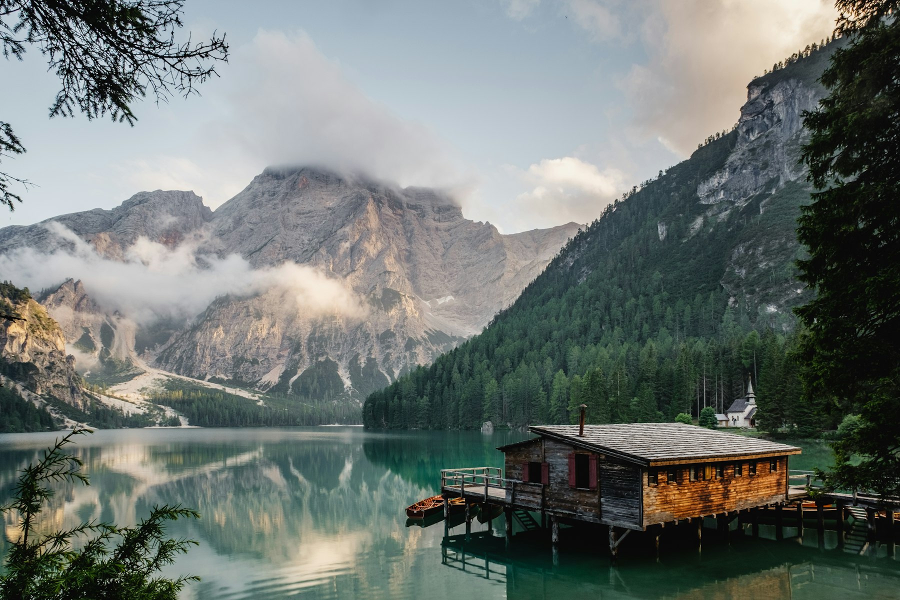 The boathouse at first light, mist rising off the lake