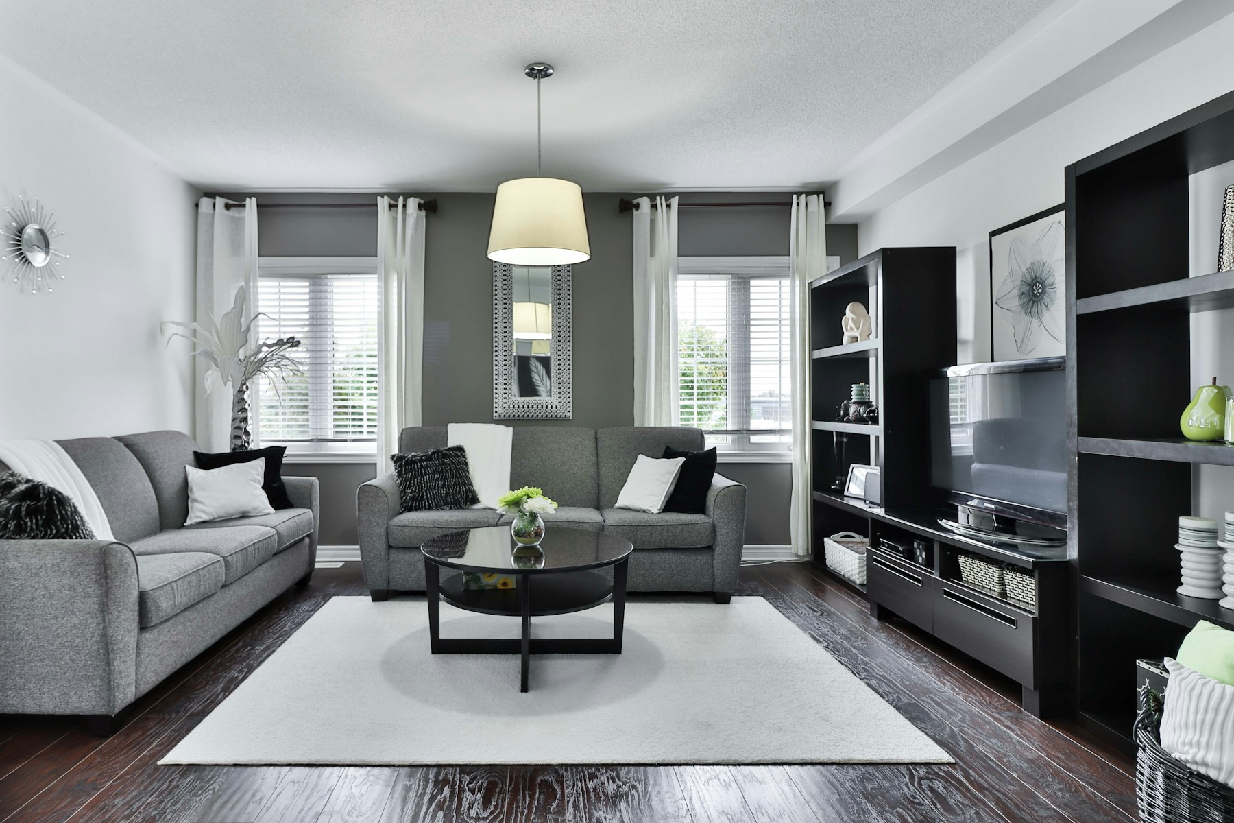 Deep green lounge with brass detailing and a marble hearth