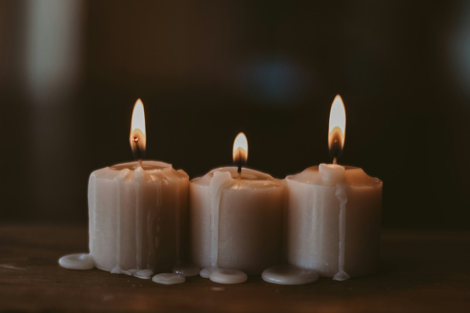 Cream candles burning low in the atelier
