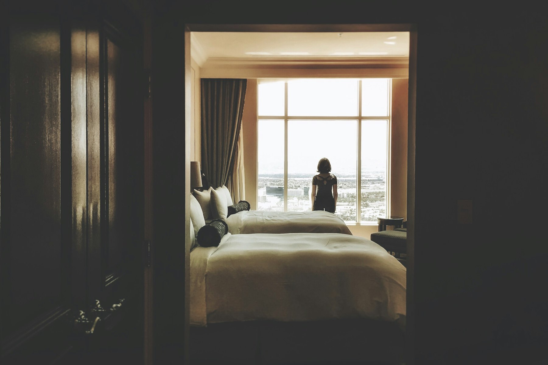 A dim rest room, a figure at the window