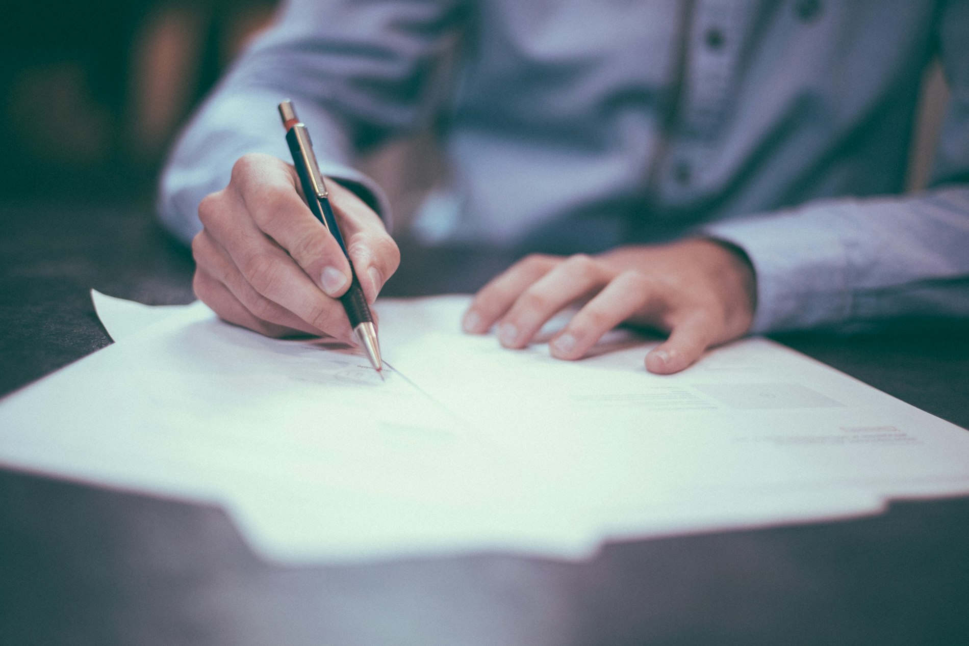 A pen resting on a single sheet of paper