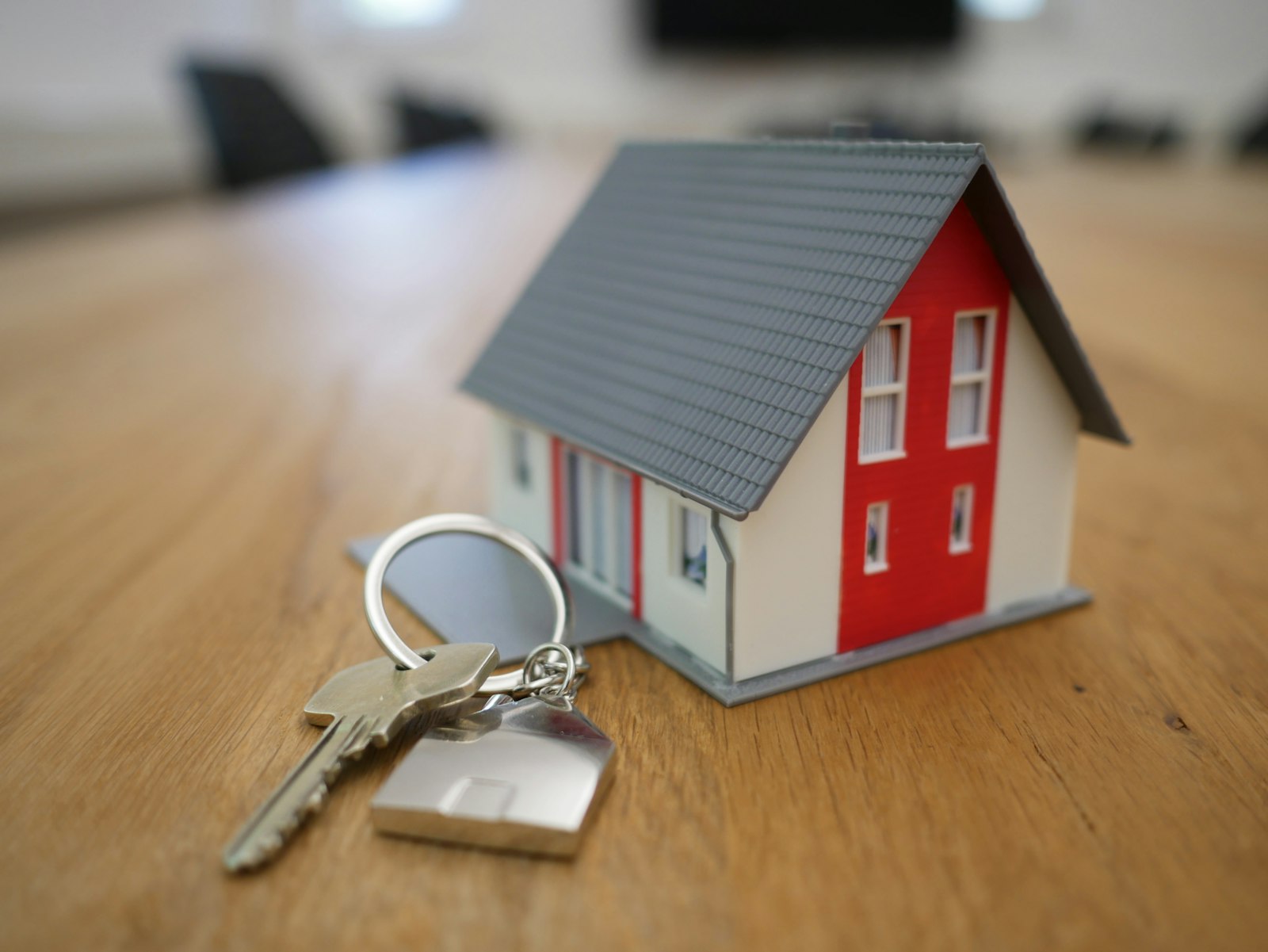 House keys beside a model house
